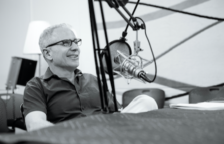 Photo of man in sound studio with microphone