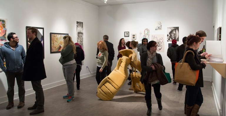 People in gallery looking at art